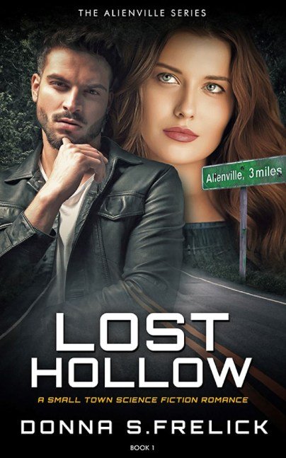 Sexy bearded young South Asian man in foreground; sexy brunette woman with green eyes in background over country road with "Alienville" road sign